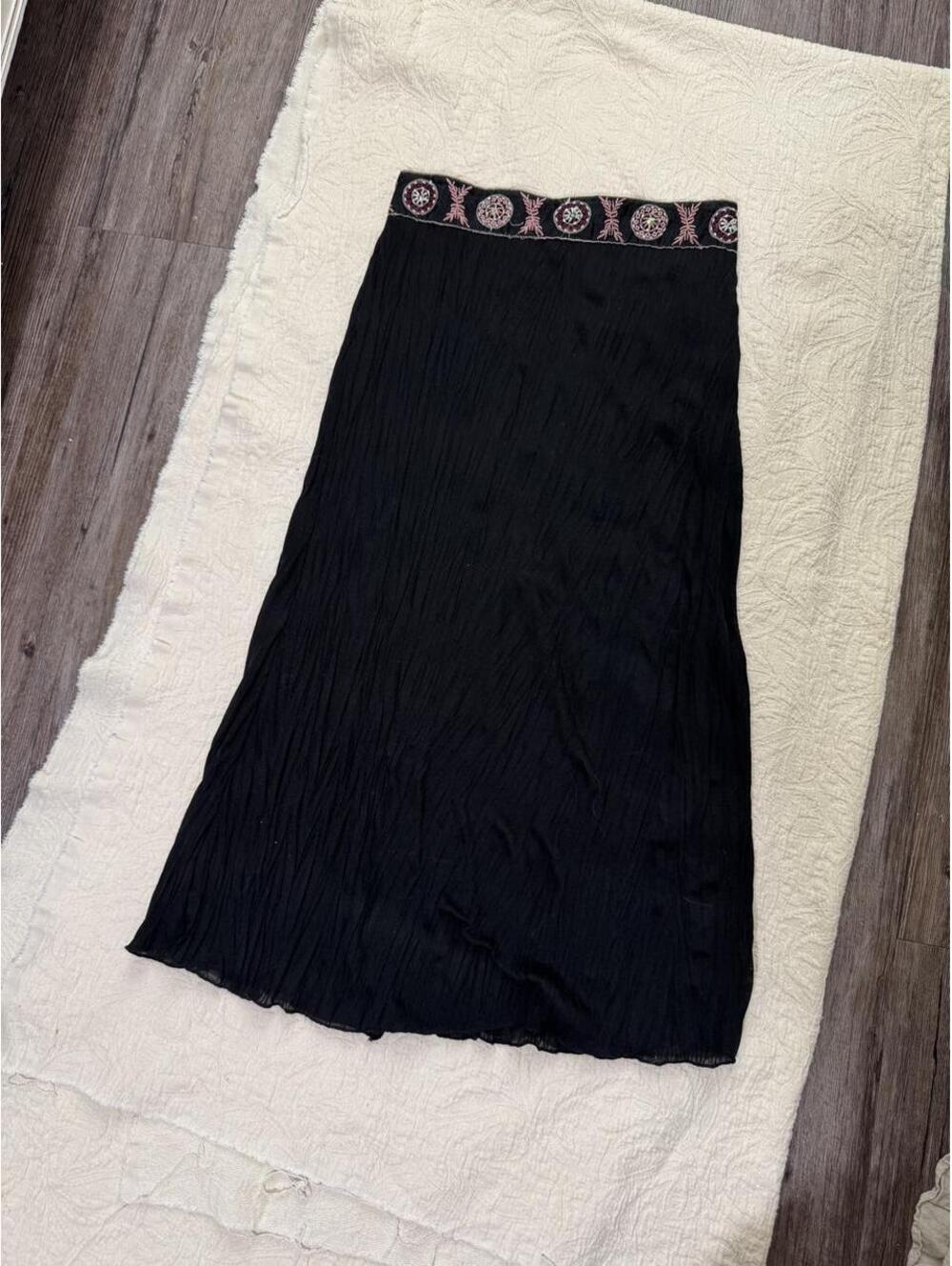 Black midi skirt with pink beaded design along the waistband